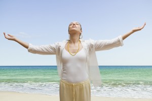 Woman at beach with arms outstretched