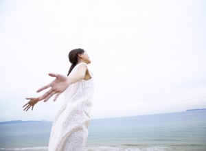 Woman by Ocean with Arms Outstretched --- Image by © Royalty-Free/Corbis